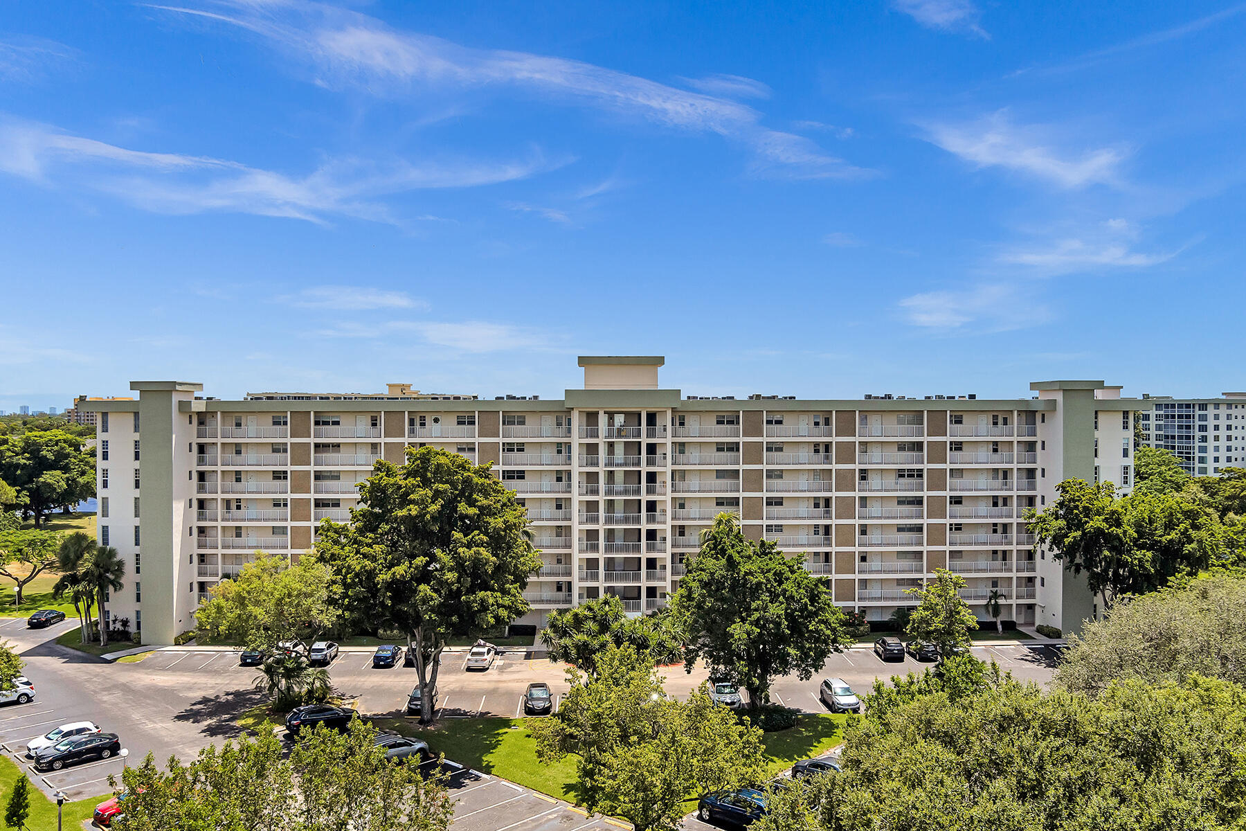 3091 North Course Drive, Unit 108 Pompano Beach, FL 33069 - Photo 39 of 42 a view of a building with a garden