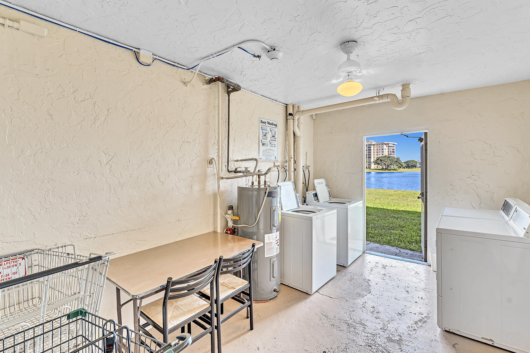 3091 North Course Drive, Unit 108 Pompano Beach, FL 33069 - Photo 41 of 42 a dining room with furniture and a window