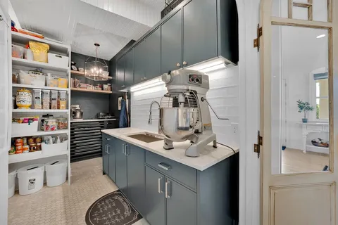 a kitchen with kitchen island a sink stove and cabinets