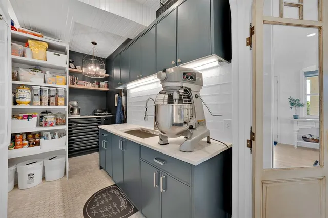 a kitchen with kitchen island a sink stove and cabinets