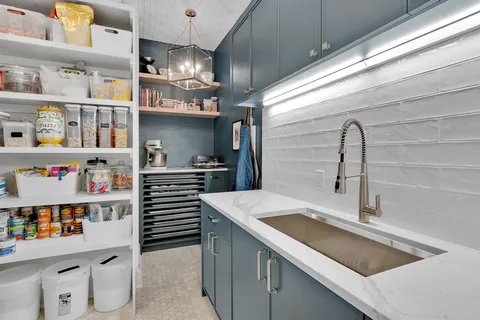 a kitchen with a refrigerator and a sink