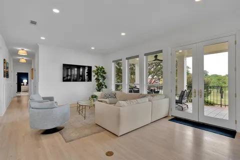 a living room with furniture and large windows