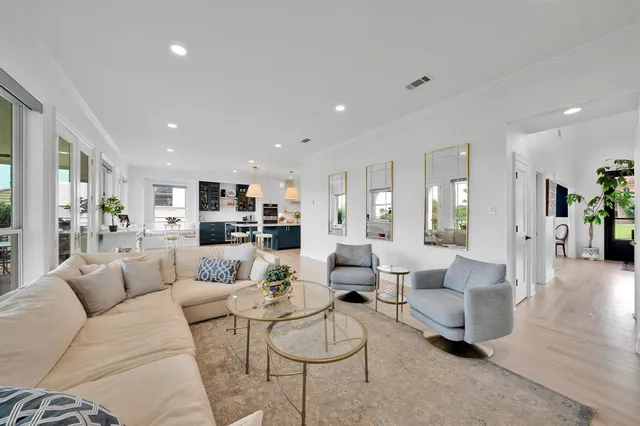 a living room with furniture and view of kitchen