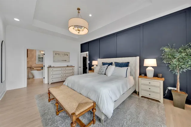 a bedroom with bed and a chandelier