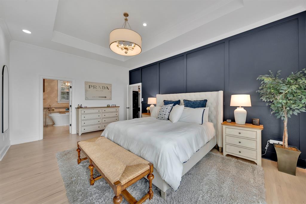 1431 Travis Circle North Irving, TX 75038 - Photo 23 of 40 a bedroom with bed and a chandelier