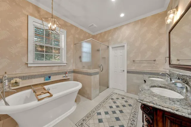 a bathroom with a granite countertop sink and a bathtub