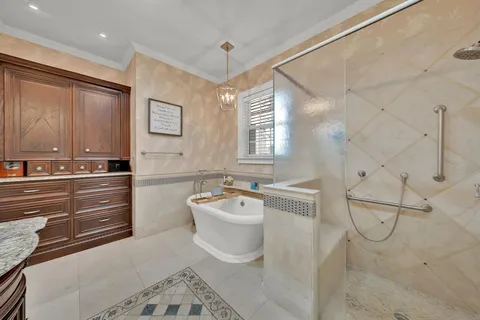 a spacious bathroom with a bathtub sink and mirror