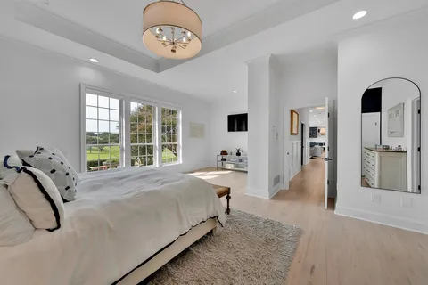 a bed room with a bed mirror and a window