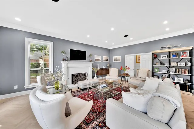 a living room with furniture a fireplace and a flat screen tv