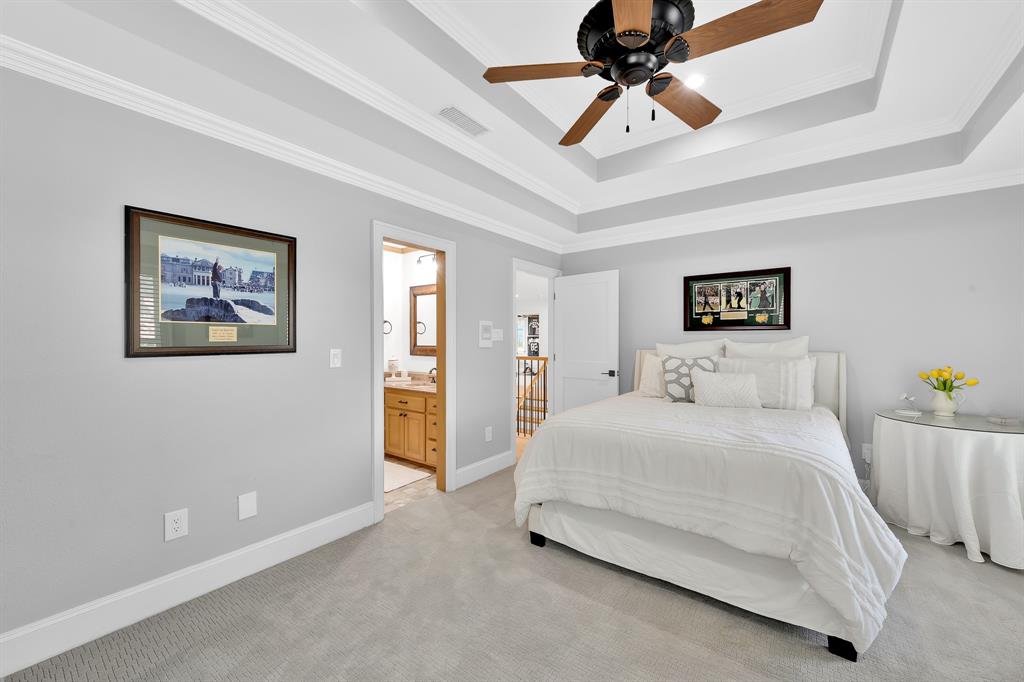 1431 Travis Circle North Irving, TX 75038 - Photo 32 of 40 a bedroom with a bed and a chandelier