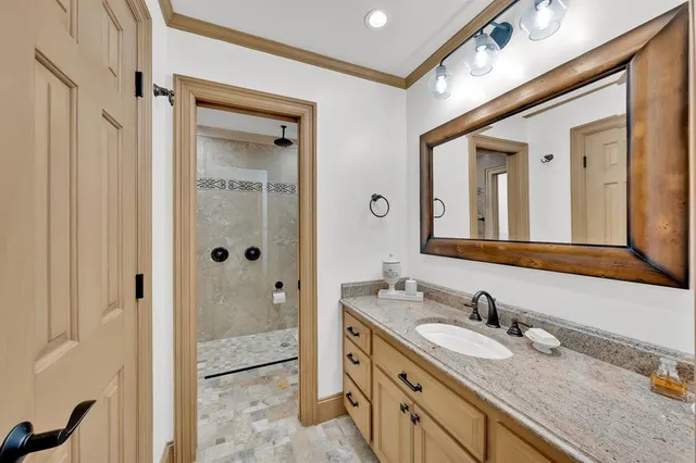 a bathroom with a granite countertop sink mirror and double