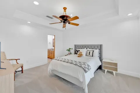 a bedroom with a bed and a chandelier