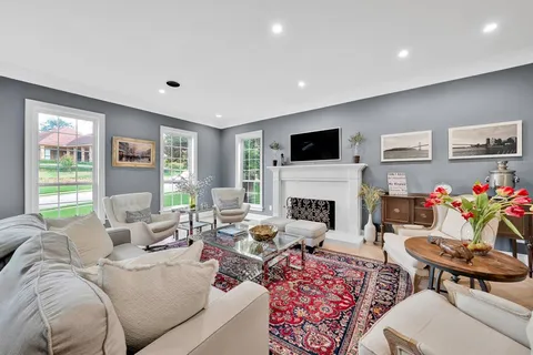 a living room with furniture fireplace and window