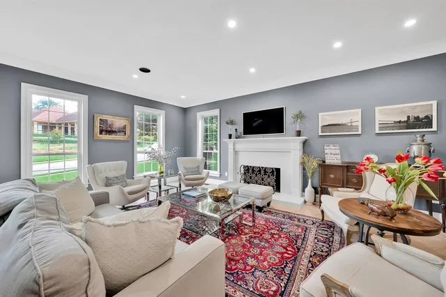 a living room with furniture fireplace and window
