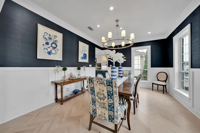 a view of a dining room with furniture and a chandelier