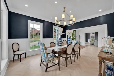 a view of a dining room with furniture wooden floor and chandelier