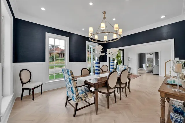 a view of a dining room with furniture wooden floor and chandelier