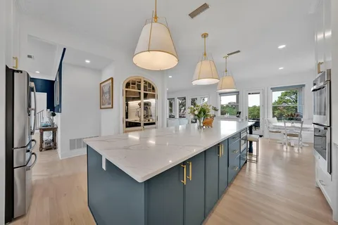 a kitchen with stainless steel appliances kitchen island a large island in the center