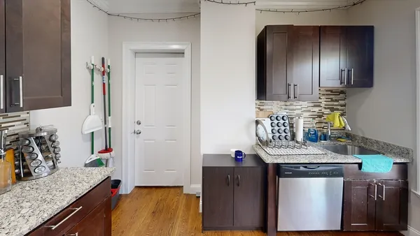 a kitchen with stainless steel appliances granite countertop a sink stove and cabinets