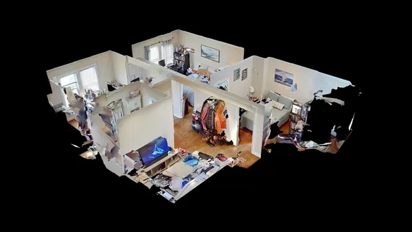 a white bed sitting in a living room
