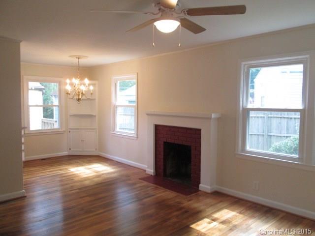 1458 Cortland Road West Charlotte, NC 28209 - Photo 2 of 9 a view of an empty room with wooden floor and a window
