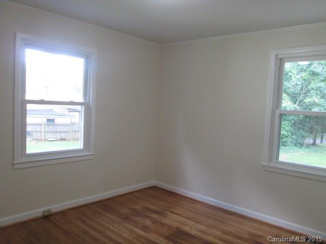 1458 Cortland Road West Charlotte, NC 28209 - Photo 7 of 9 an empty room with wooden floor and windows