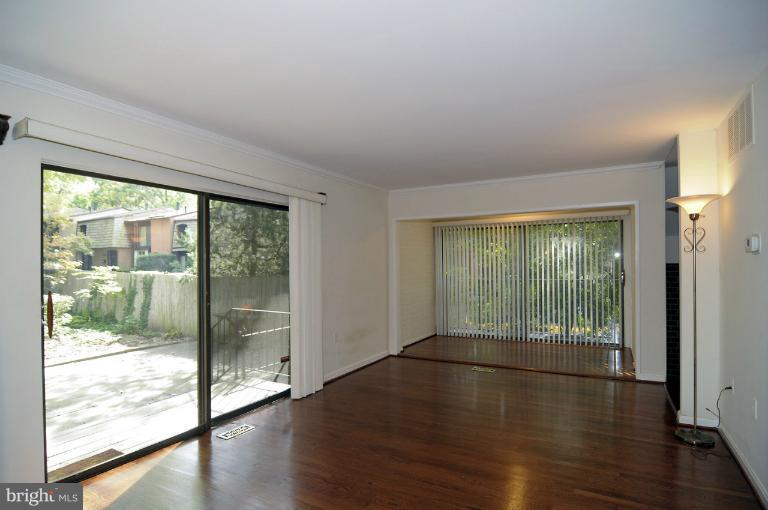 7946 Inverness Ridge Road Potomac, MD 20854 - Photo 2 of 25 a view of an empty room with wooden floor and a window
