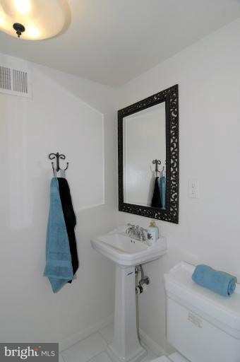 7946 Inverness Ridge Road Potomac, MD 20854 - Photo 11 of 25 a bathroom with a sink and a mirror