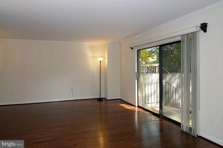 7946 Inverness Ridge Road Potomac, MD 20854 - Photo 15 of 25 a view of an empty room with wooden floor and a window