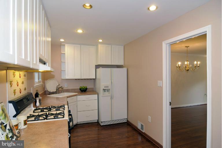 7946 Inverness Ridge Road Potomac, MD 20854 - Photo 16 of 25 a kitchen with a refrigerator and a stove top oven