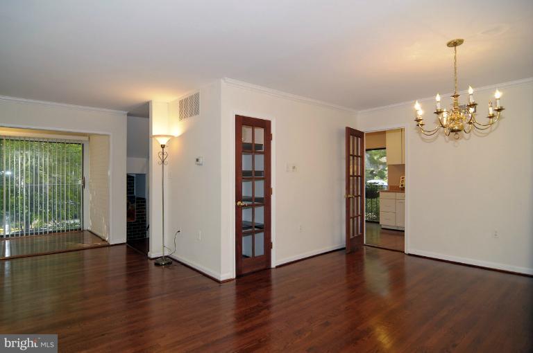 7946 Inverness Ridge Road Potomac, MD 20854 - Photo 6 of 25 a view of a livingroom with wooden floor and a chandelier