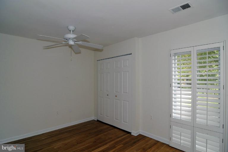 7946 Inverness Ridge Road Potomac, MD 20854 - Photo 7 of 25 a view of an empty room with wooden floor and a window