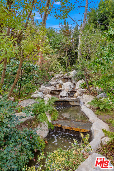 2383 Mandeville Canyon Road Los Angeles, CA 90049 - Photo 14 of 51 a view of a yard with plants