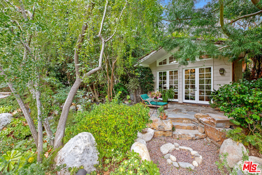 2383 Mandeville Canyon Road Los Angeles, CA 90049 - Photo 15 of 51 a front view of a house with garden