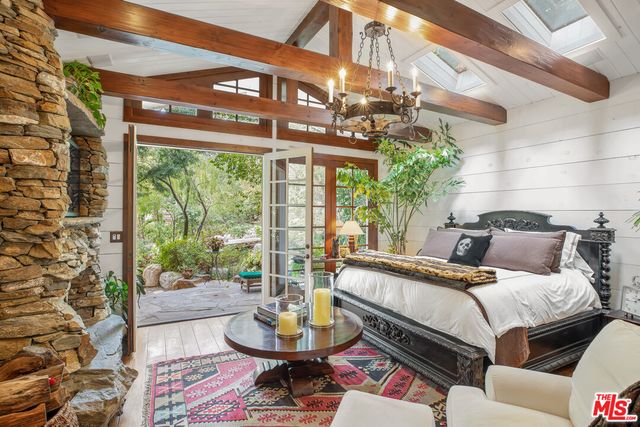 a bedroom with a bed and a chandelier