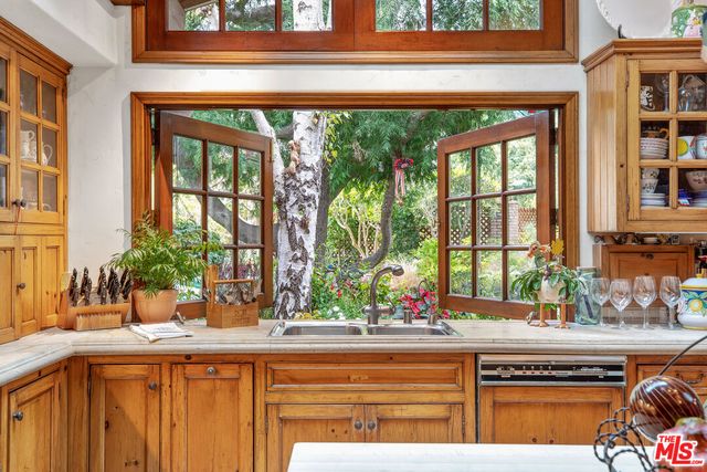 a kitchen with a sink and large window