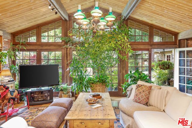 a outdoor living space with furniture potted plant and a large window