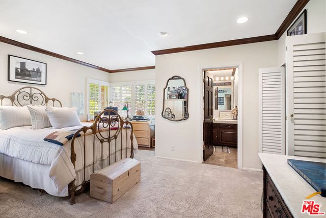 a living room with furniture a window and a clock