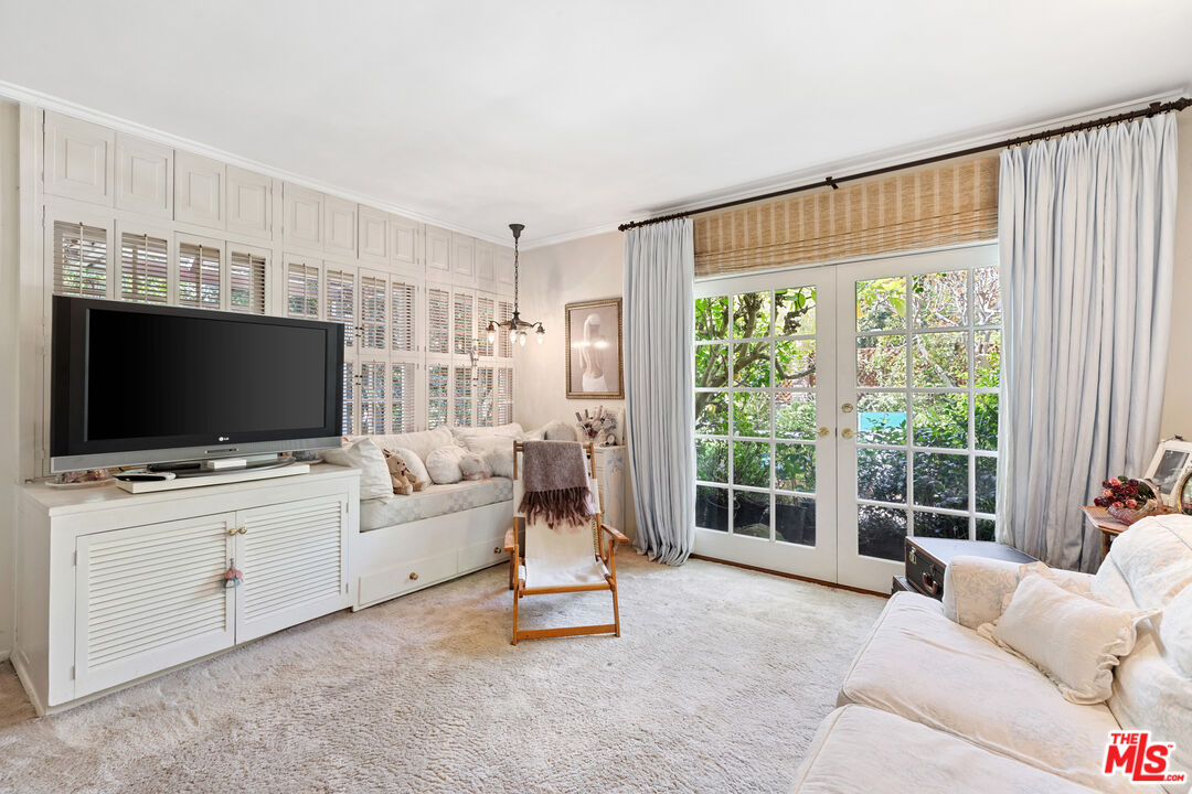 2383 Mandeville Canyon Road Los Angeles, CA 90049 - Photo 34 of 51 a living room with furniture a flat screen tv and a large window