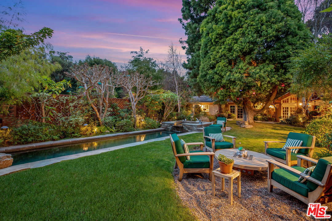 2383 Mandeville Canyon Road Los Angeles, CA 90049 - Photo 35 of 51 an outdoor sitting area with couch and wooden fence