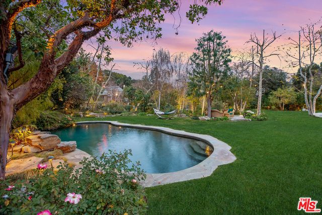 a view of a swimming pool with a yard