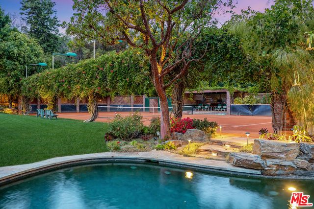 a view of swimming pool with a yard