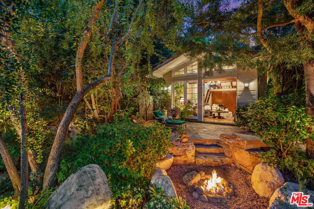 2383 Mandeville Canyon Road Los Angeles, CA 90049 - Photo 41 of 51 a backyard of a house with lots of green space