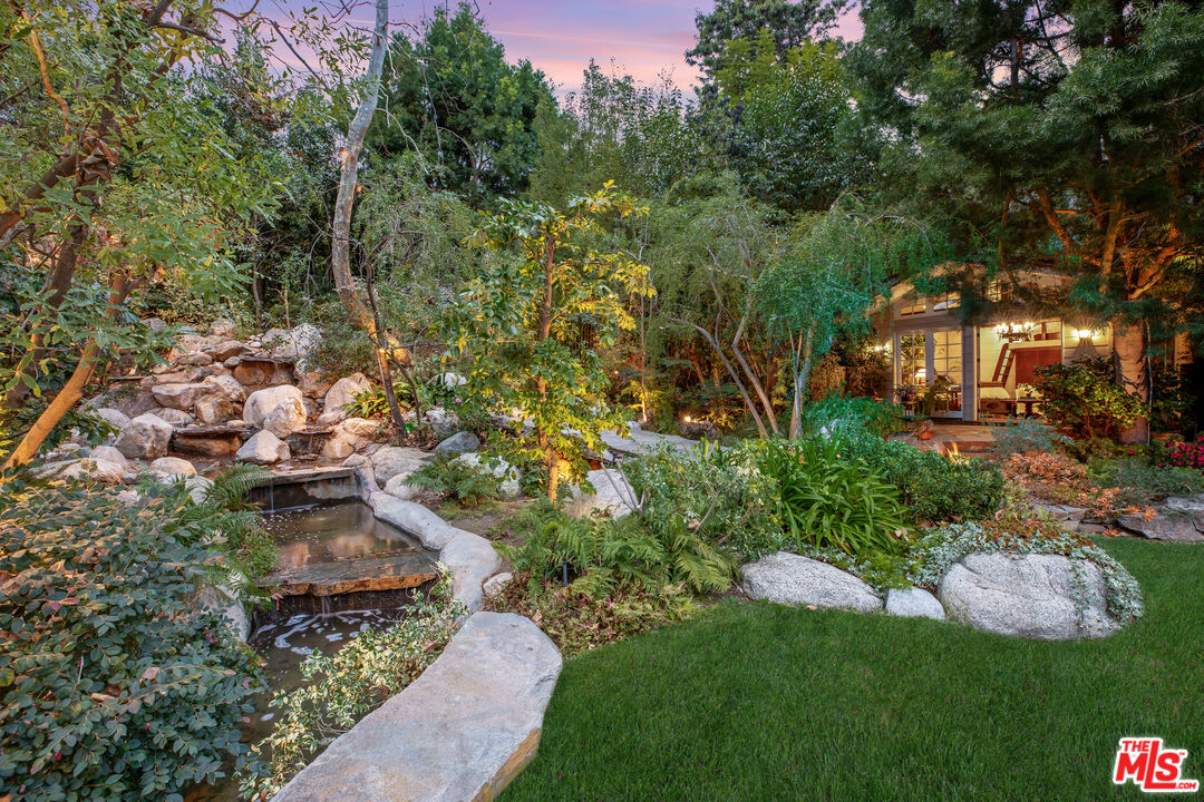 2383 Mandeville Canyon Road Los Angeles, CA 90049 - Photo 42 of 51 a view of a garden with plants and large trees