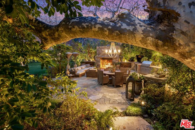a view of a patio with table and chairs and potted plants