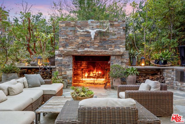 a living room with patio furniture and a fireplace