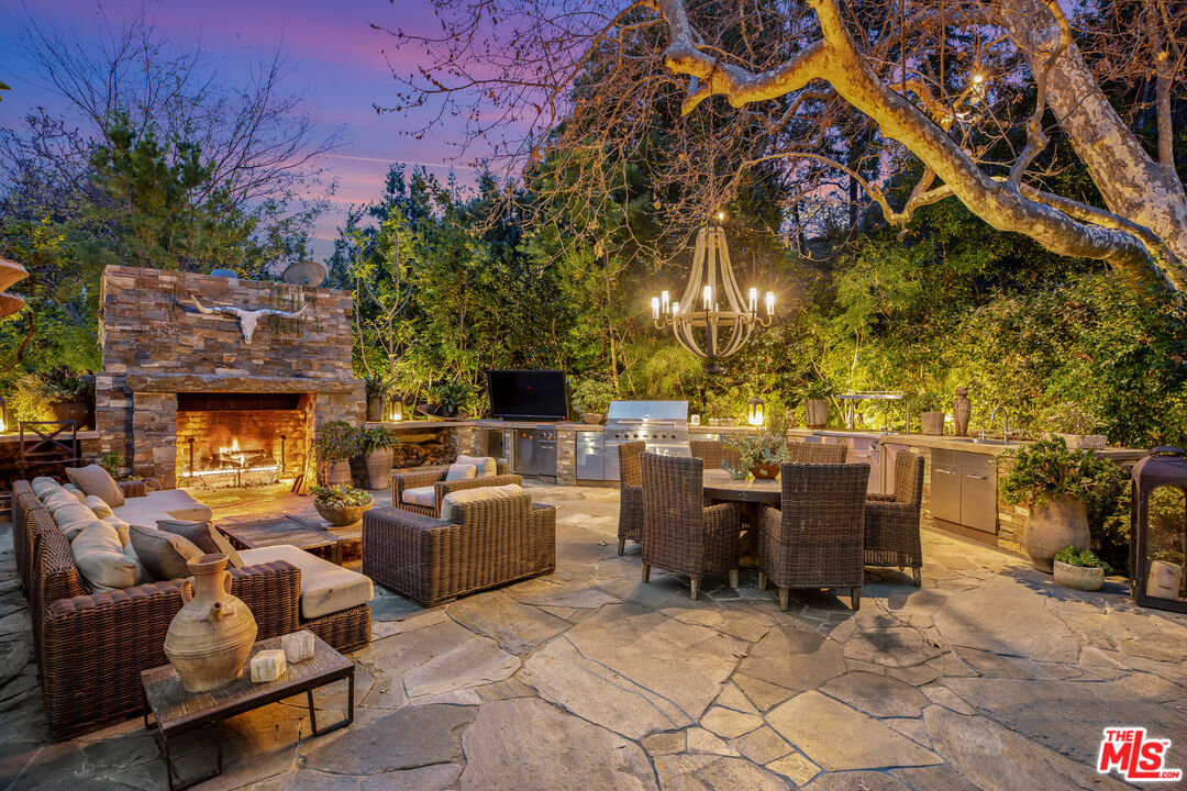 2383 Mandeville Canyon Road Los Angeles, CA 90049 - Photo 48 of 51 a living room with patio furniture and a fireplace