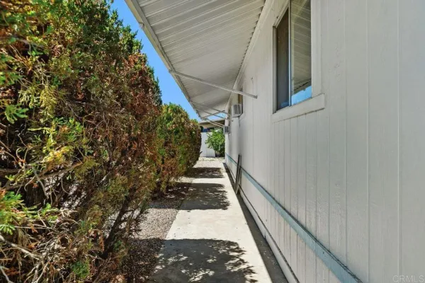 a view of a pathway of a house with wooden stairs
