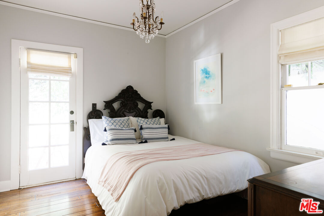 4207 Dundee Drive Los Angeles, CA 90027 - Photo 18 of 33 a bedroom with a bed and wooden floor