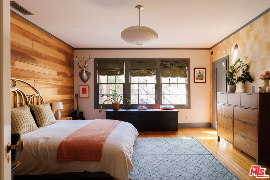 4207 Dundee Drive Los Angeles, CA 90027 - Photo 19 of 33 a bedroom with a bed and a large window